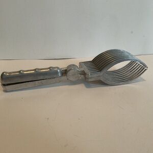 Vintage metal roast fork, meat tongs for slicing, roast for roast dinner.